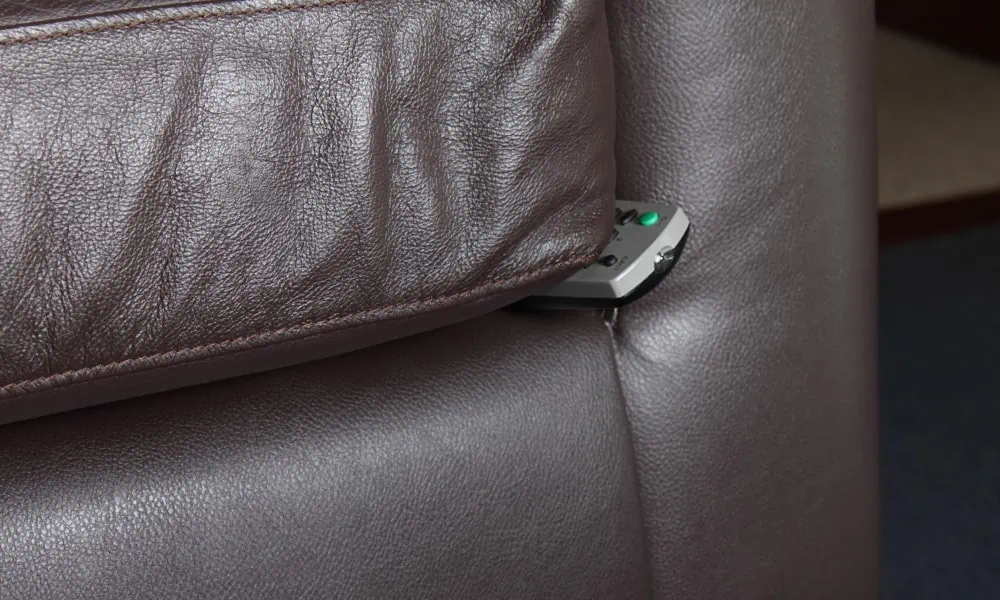 Remote control hidden on the seat of the couch