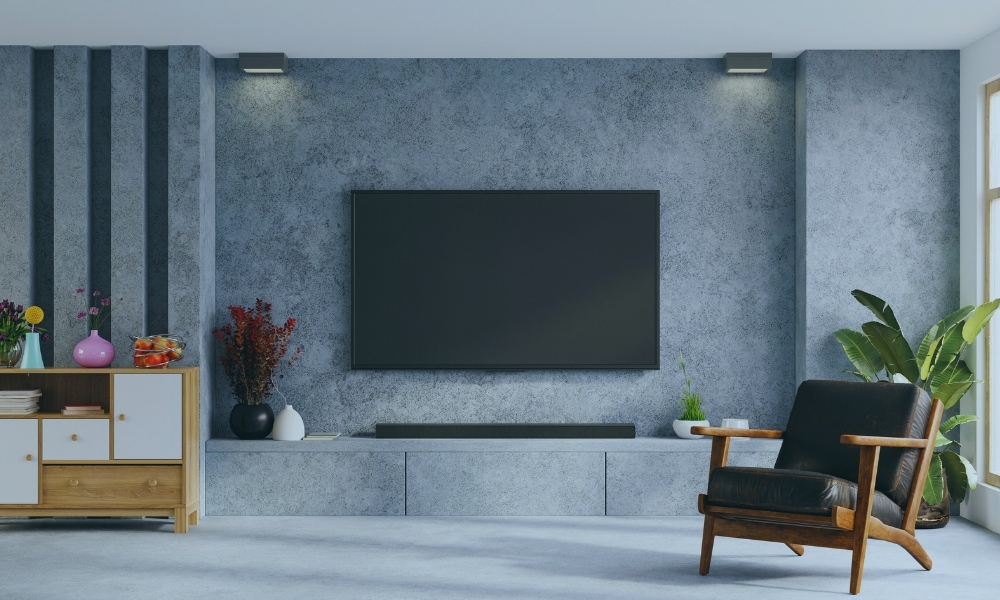 A soundbar on a tabletop under a TV