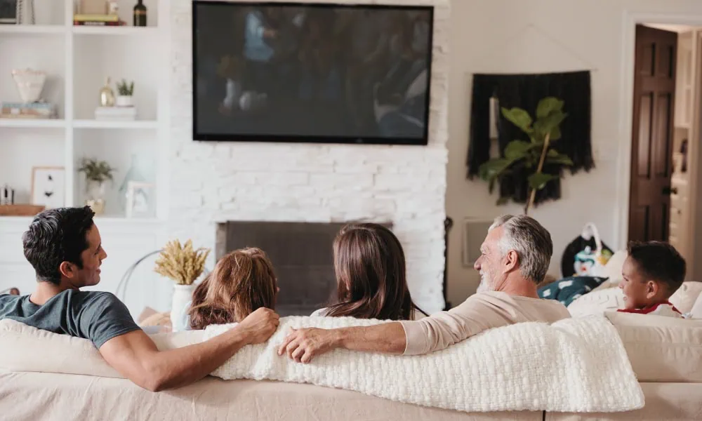 Family on the living room watching together